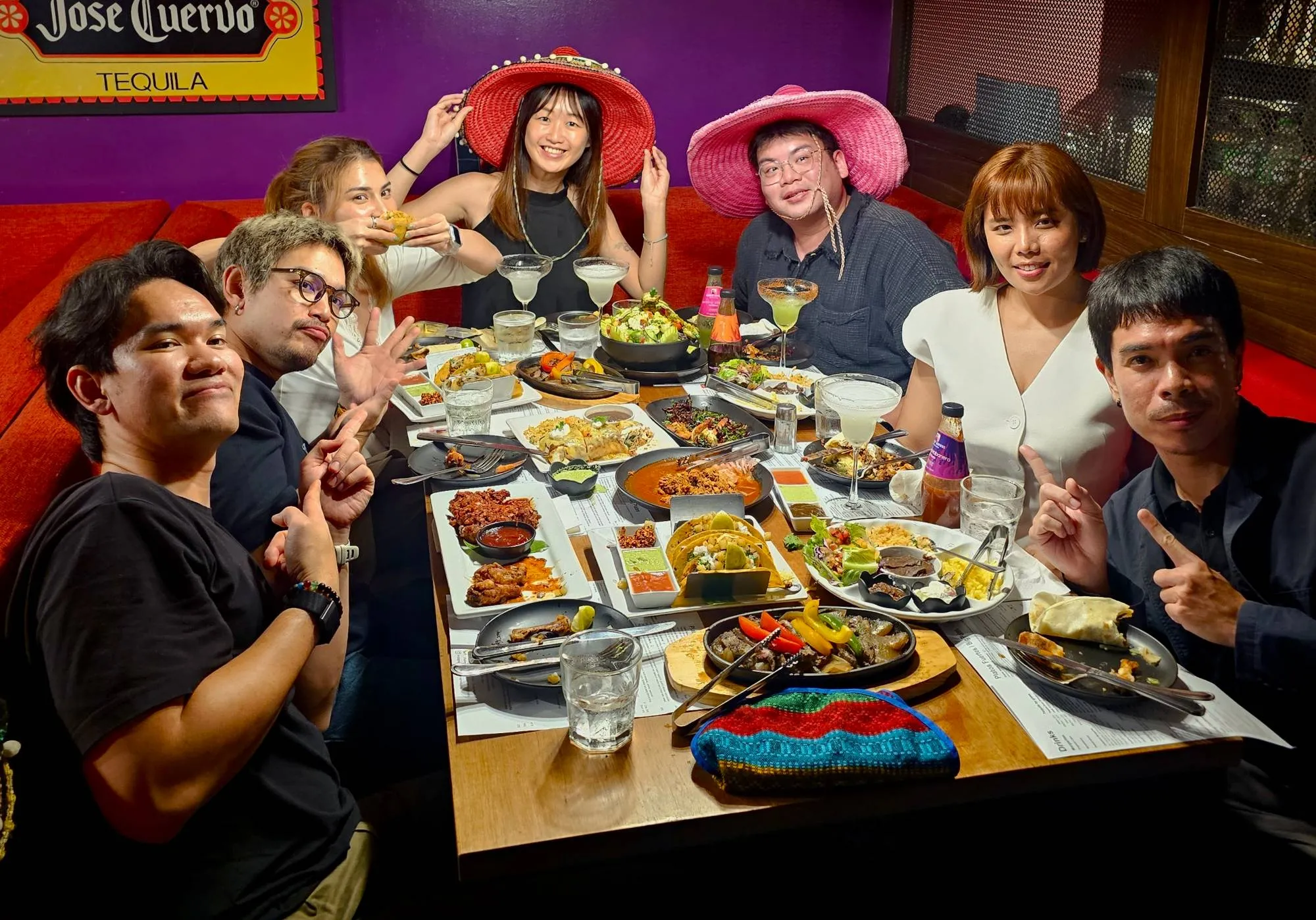 A group of friends in sombreros sharing tacos, fajitas and margaritas at Charley Brown's