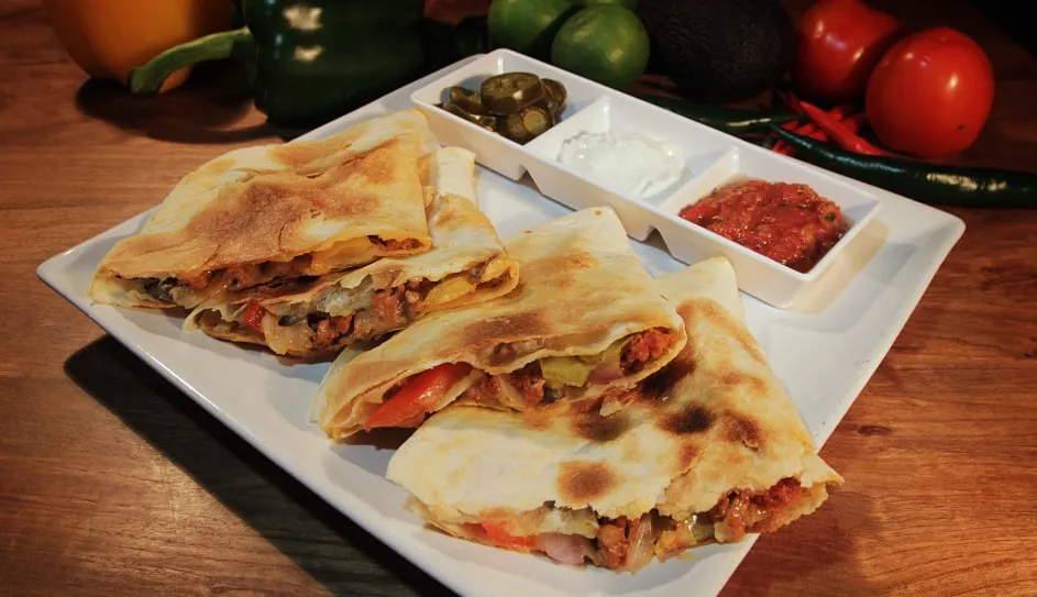 Spicy chorizo quesadilla wedges with salsas